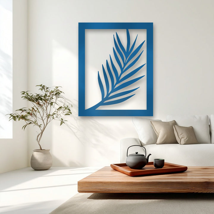 The brightest area, a gleaming white wall, enhances the vibrant blue palm leaf metal decoration wall art with abundant sunlight.
