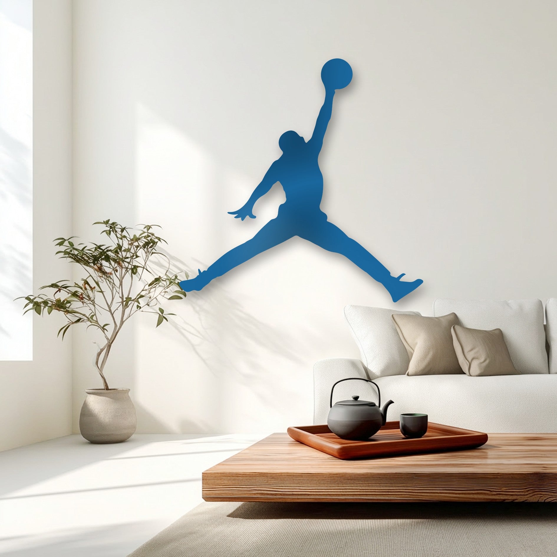 The vibrant blue silhouette of a basketball jump player, forming a captivating piece of decorative metal art, dominates the modern minimalist wall.