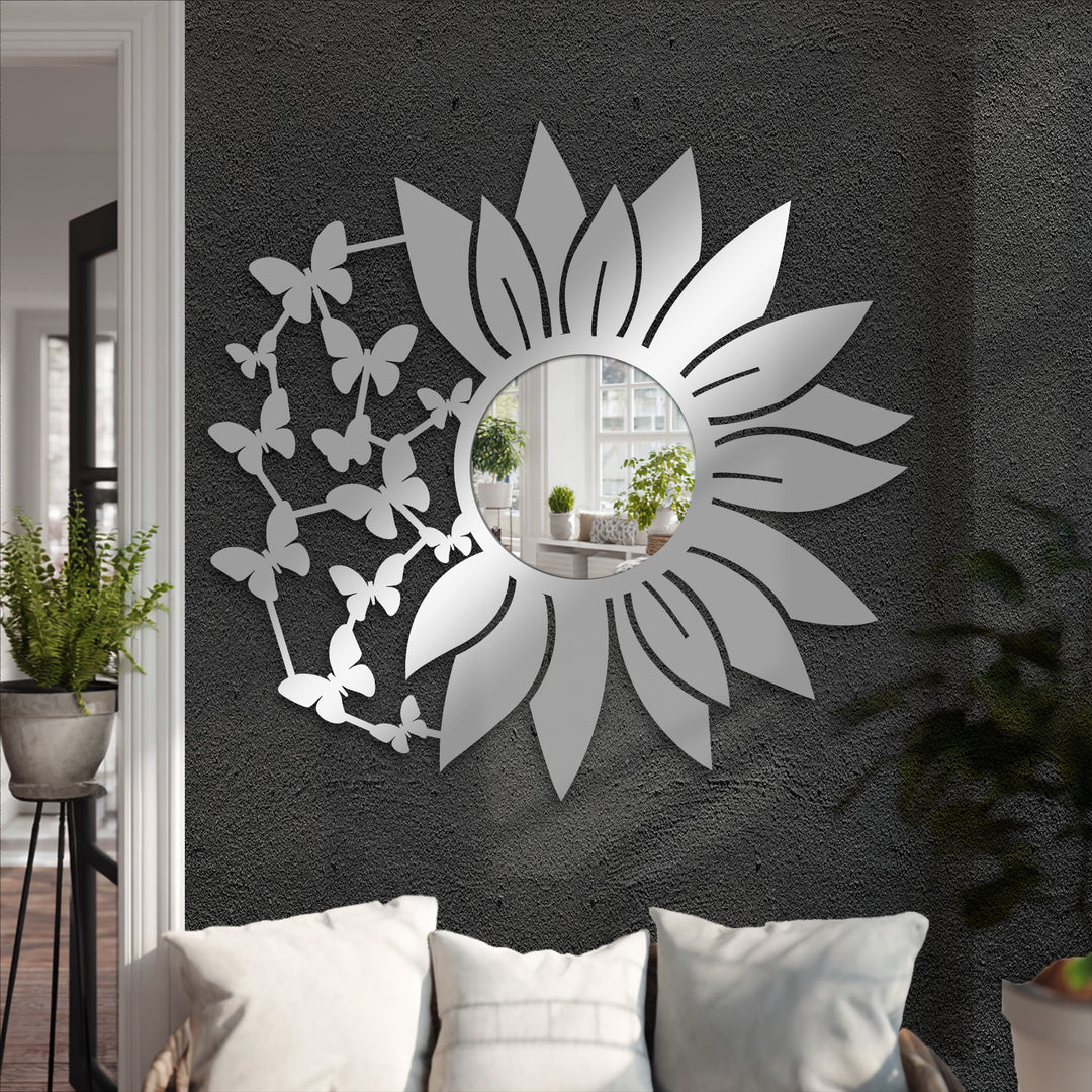 Defined by its intricate edge of delicate butterflies and a sleek floral border, this decorative framed wall mirror adds an artistic touch.