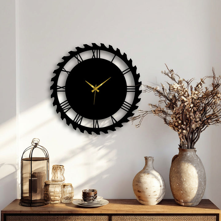 Vast negative space on a bright wall surrounds the striking industrial gear-style Roman numeral metal wall decor, emphasizing its bold black design.