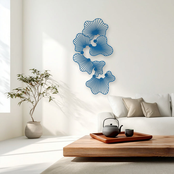 The bright white wall of a minimalist interior showcases the striking abstract floral metal artwork with its modern line flower design.