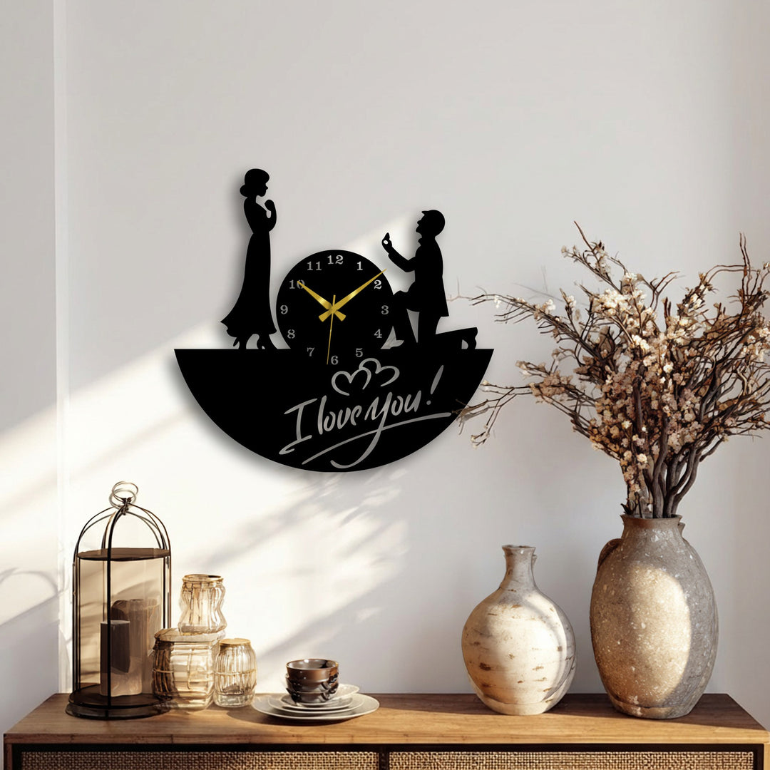 The softest element is the diffused light highlighting this unique metal wall art clock depicting a romantic proposal with 'I love you!' written on its base.