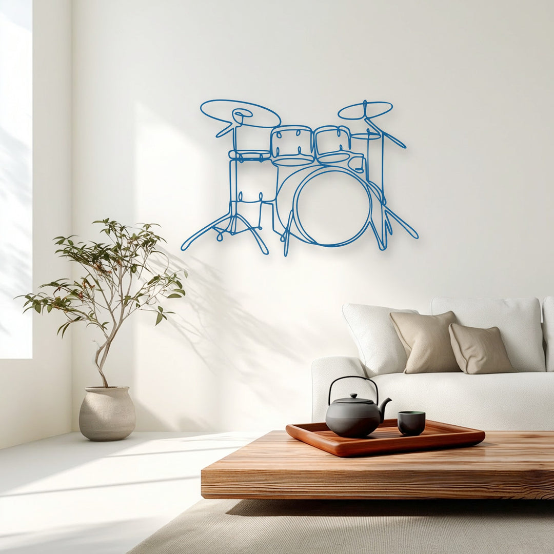 With moderate color saturation, a vibrant blue minimalist drum set metal wall decor hangs above a sleek white sofa in a serene, modern living space.