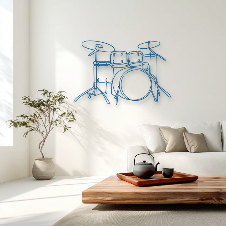 With moderate color saturation, a vibrant blue minimalist drum set metal wall decor hangs above a sleek white sofa in a serene, modern living space.