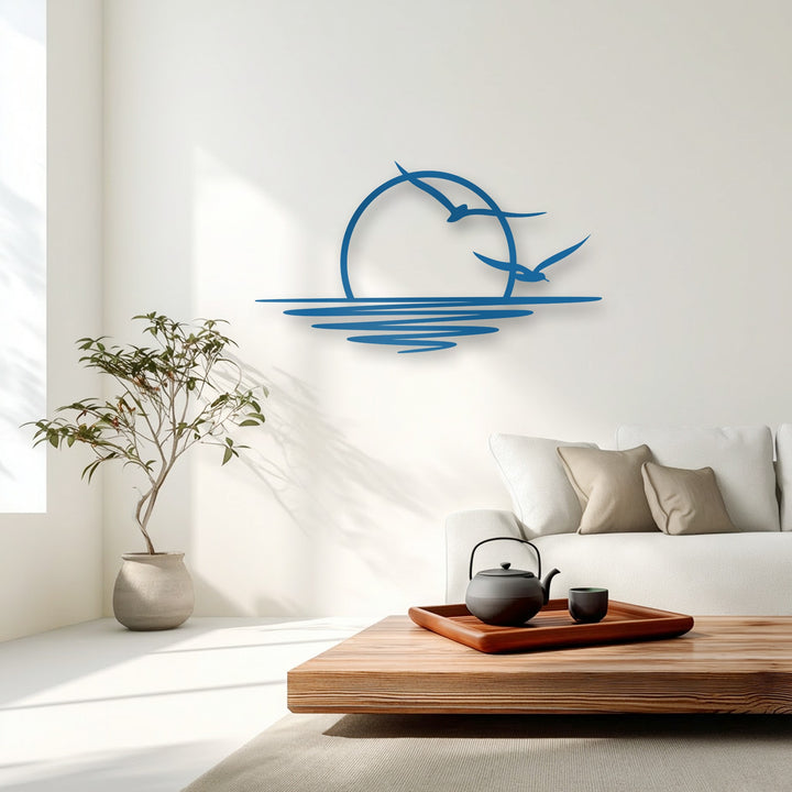 The pristine white wall highlights the vivid blue sunset seagull metal artwork, casting soft shadows for a clean coastal aesthetic.