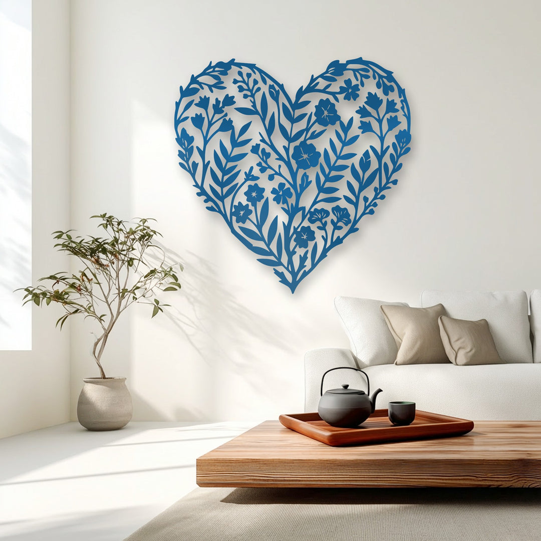 The darkest area, a black teapot and cup, sits below the striking blue unique metal wall art, a floral heart silhouette.