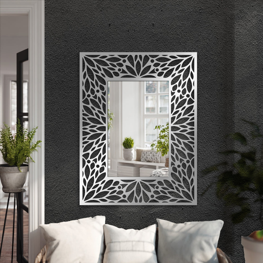 Textured dark gray background highlights the intricate floral metal wall decor mirror, enhancing its elegant frame design.
