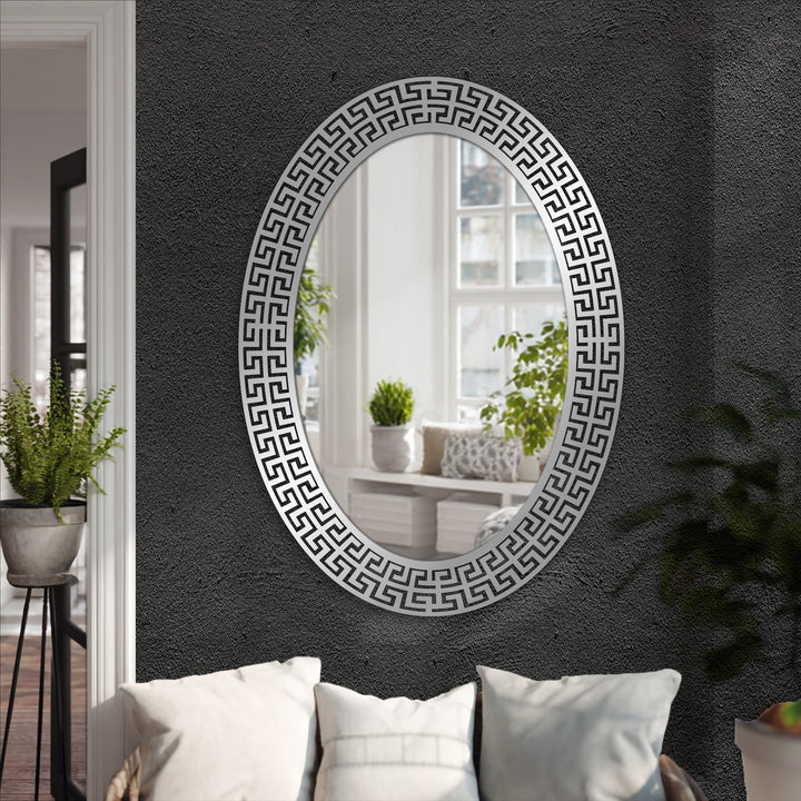 Central stylish oval floor mirror with Neo Greco patterned metal frame exemplifies decorating with wall mirrors for modern interiors.