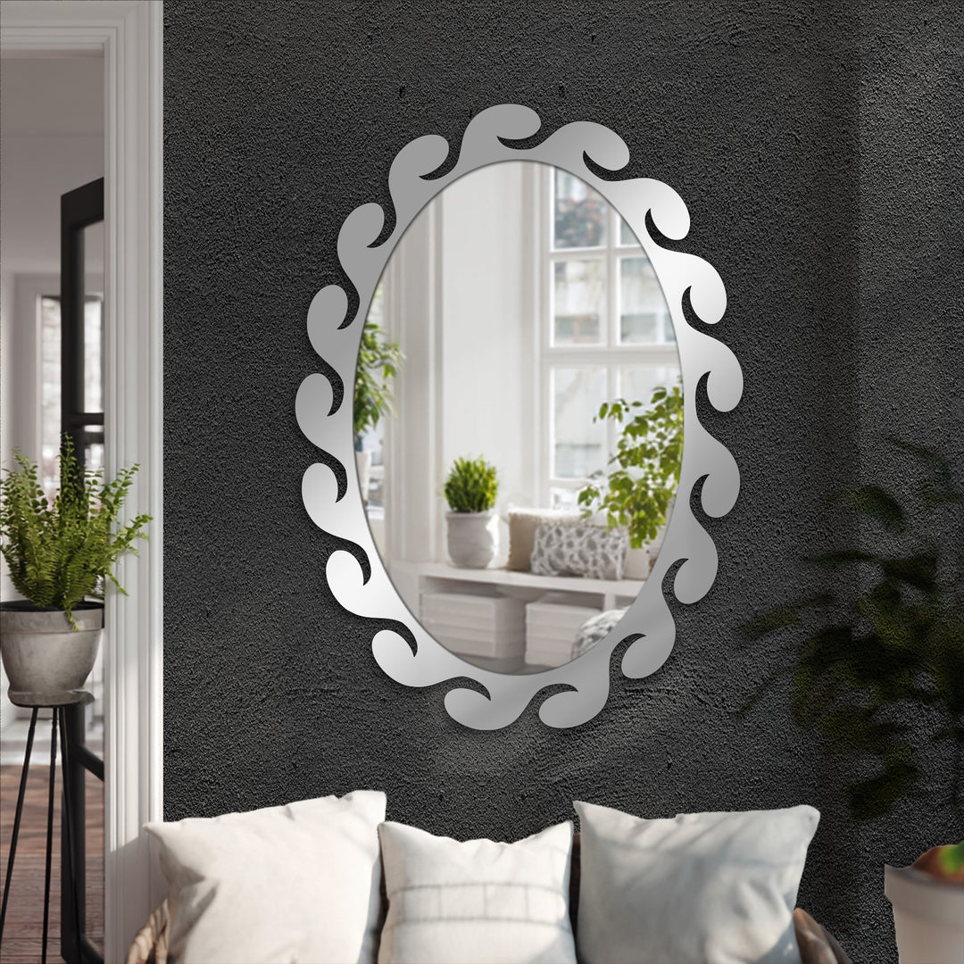 Vertically oriented, oval-shaped mirror showcasing the art of decorating with wall mirrors, featuring a unique fluid wave-sculpted frame.