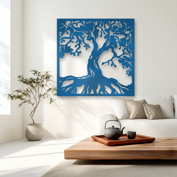 A wooden coffee table with a sleek black teapot and cup on a dark tray complements the unique metal wall art of a majestic tree silhouette.