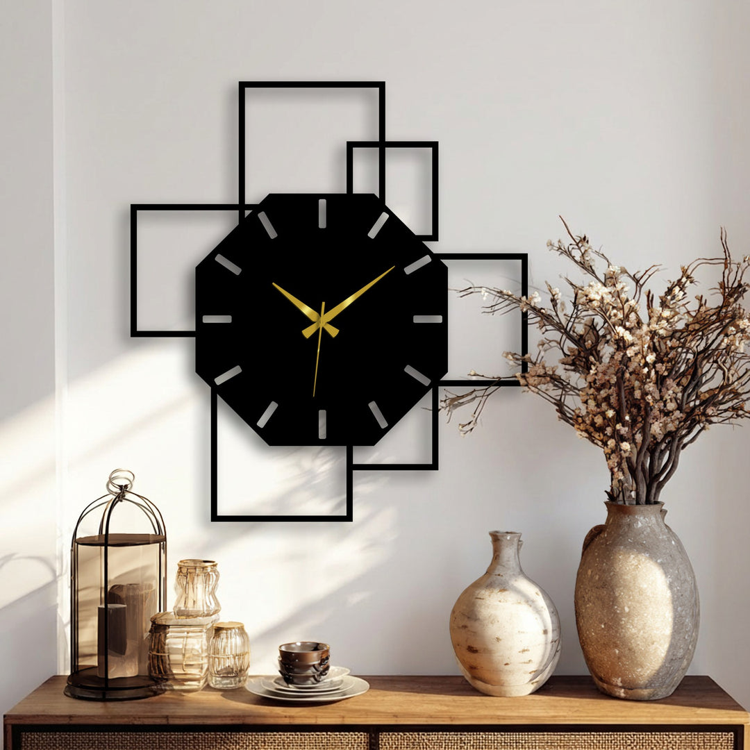 Warm color temperature highlights the black octagonal geometric metal wall clock with square frame as modern decoration wall art on a light wall.