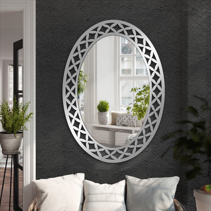 Layered depth is created in this geometric petal frame oval mirror reflecting a bright room, adding dimension to a wall with this modern wall mirrors piece.