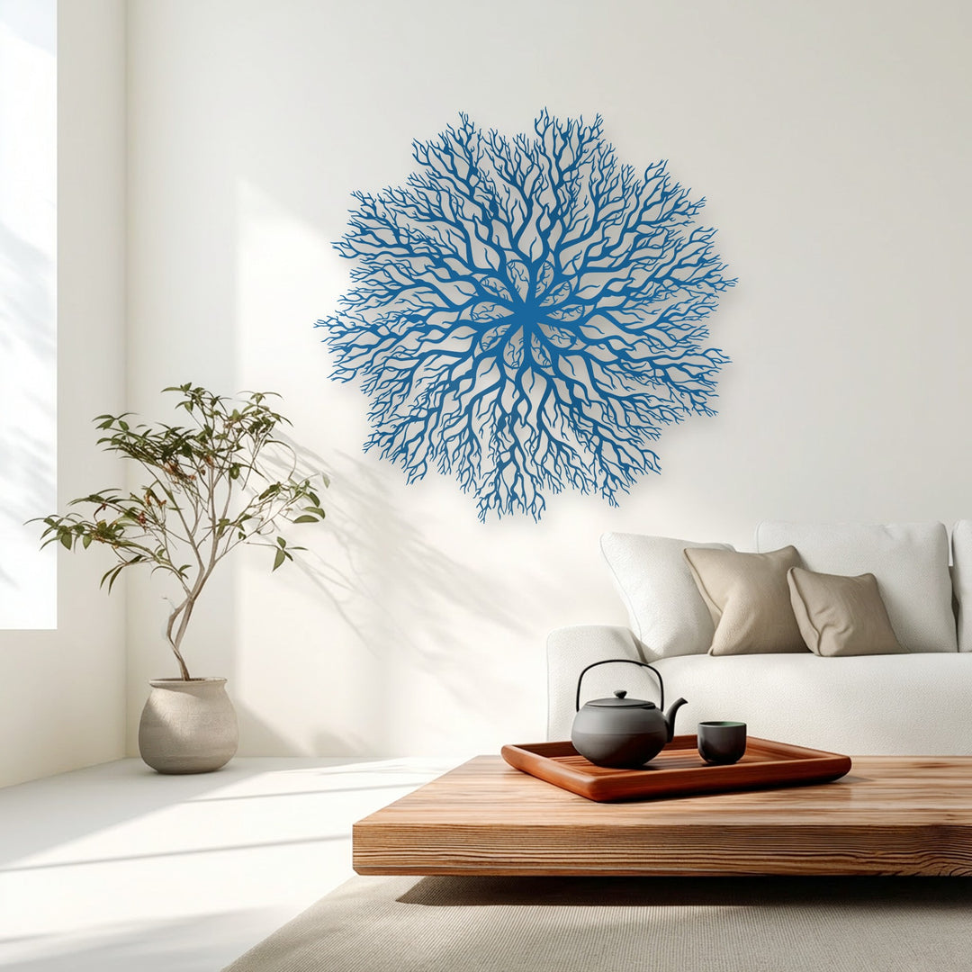 The intricate negative space of a sapphire tree roots mandala metal wall decor reveals delicate, interwoven branches against a clean white wall.