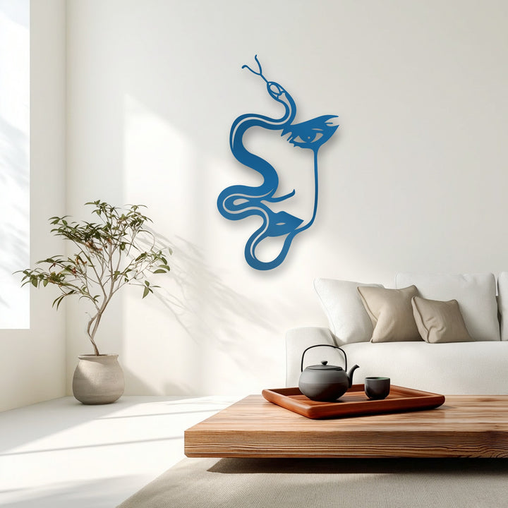 The stark color contrast of the deep cobalt blue abstract woman and serpent silhouette metal artwork against the pristine white wall creates a striking visual.