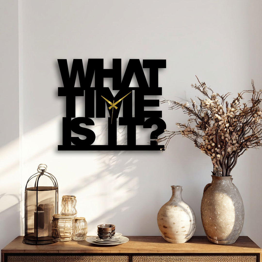 Light plays across the 'What Time Is It' decorative metal art clock, casting dramatic shadows that accentuate its bold text design.