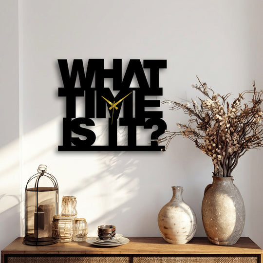 Light plays across the 'What Time Is It' decorative metal art clock, casting dramatic shadows that accentuate its bold text design.