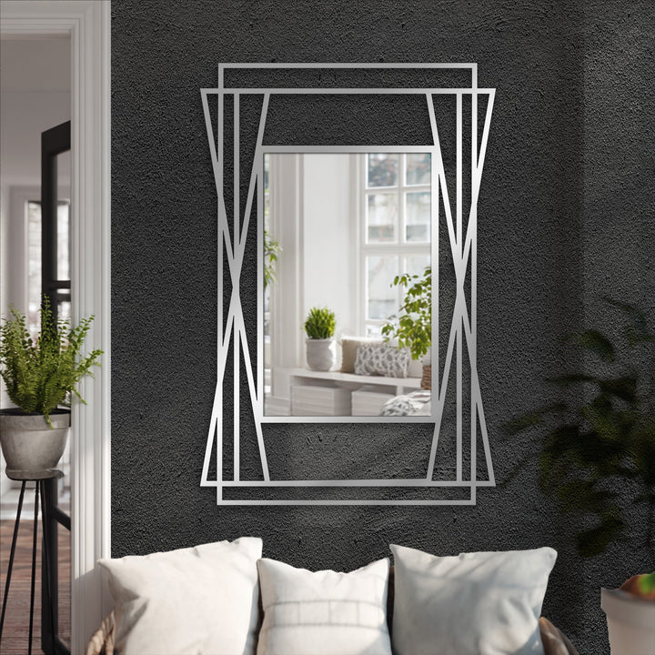 Visual rhythm is created by the layered, symmetrical metal geometry of this modern, angular framed wall mirror, offering a decorative metal art style.