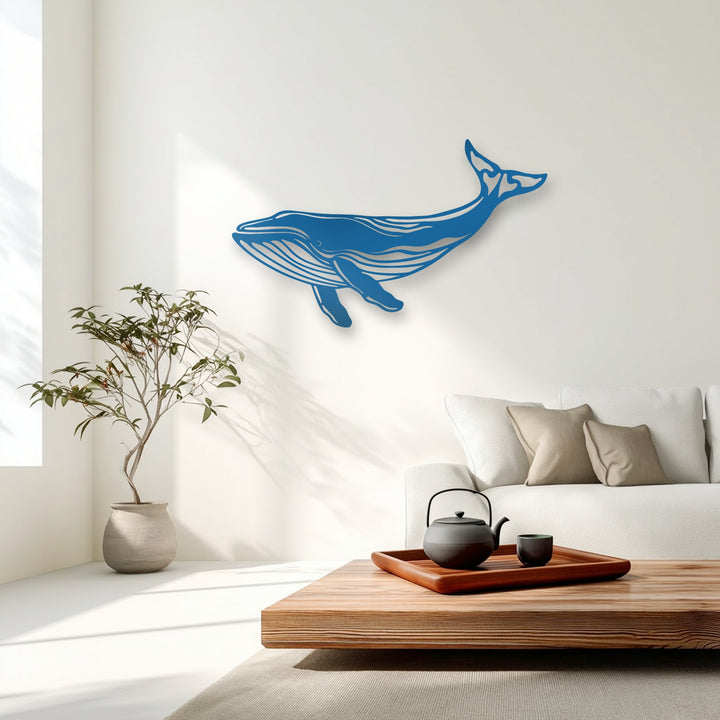 A scene with a balanced color temperature features a majestic blue whale decorative metal art piece adorning a brightly lit, pristine ivory wall.