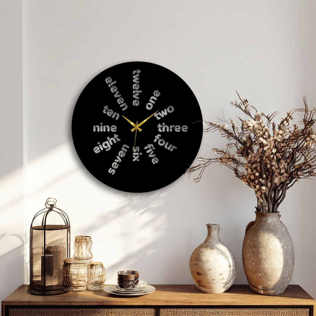 The Word Time metal artwork appears to dynamically spin as each hour, represented by stylized words, creates a sense of constant movement on this modern metal wall clock.