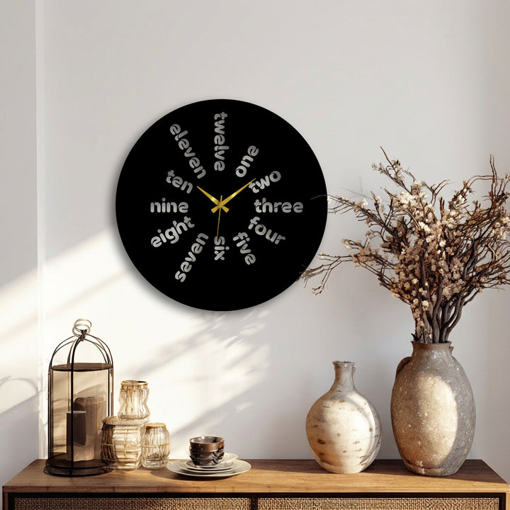 The Word Time metal artwork appears to dynamically spin as each hour, represented by stylized words, creates a sense of constant movement on this modern metal wall clock.