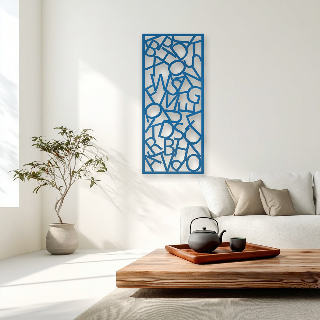 The crisp white background, illuminated by natural light, highlights the unique metal wall art featuring abstract typography chaos.