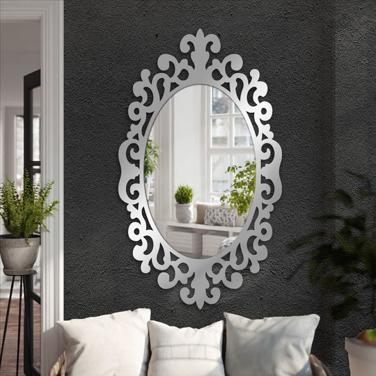 Oval mirror for wall decor showcases intersecting curves and symmetrical flourishes creating an elegant frame around the reflective surface.