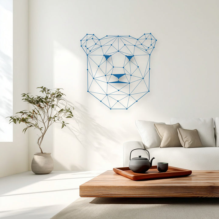 Soft beige throw pillows on the plush white sofa complement the striking blue geometric bear metal art for wall, illuminated by warm sunlight.