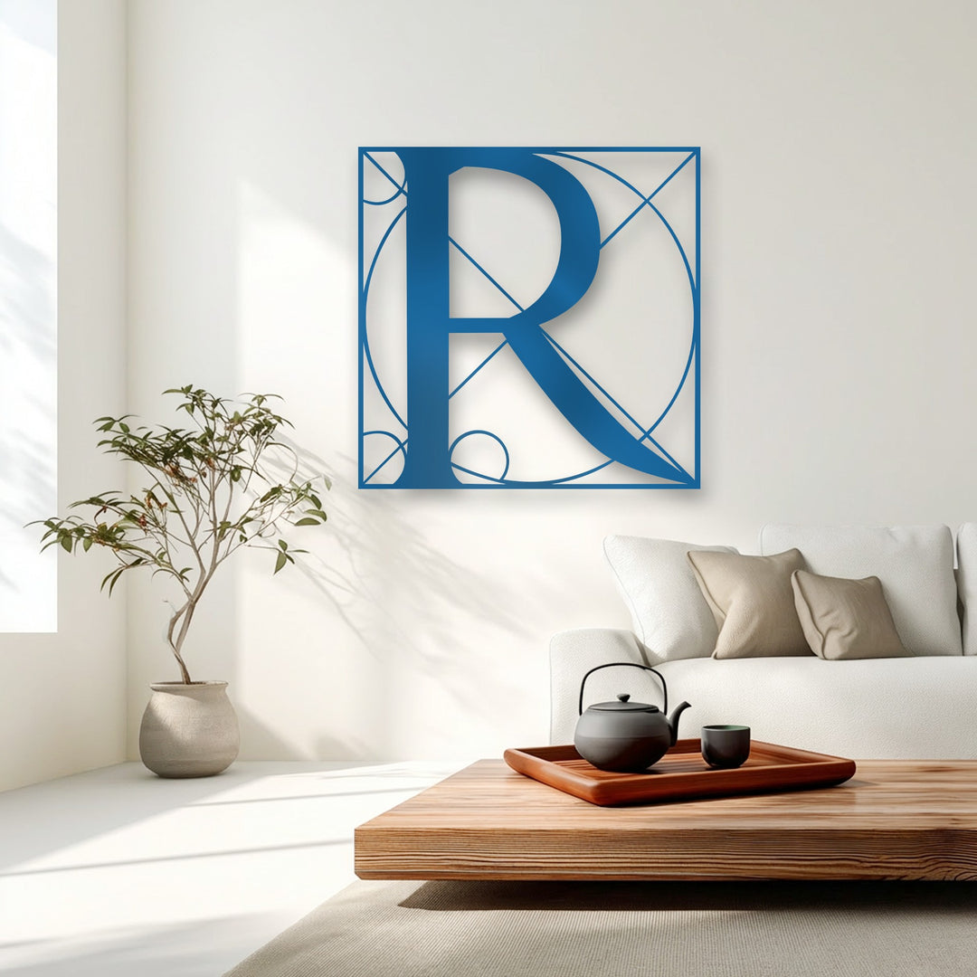 The crisp, azure blue borders of the Geometric Letter R metal art for wall form intricate lines and circles around the stylish monogram.