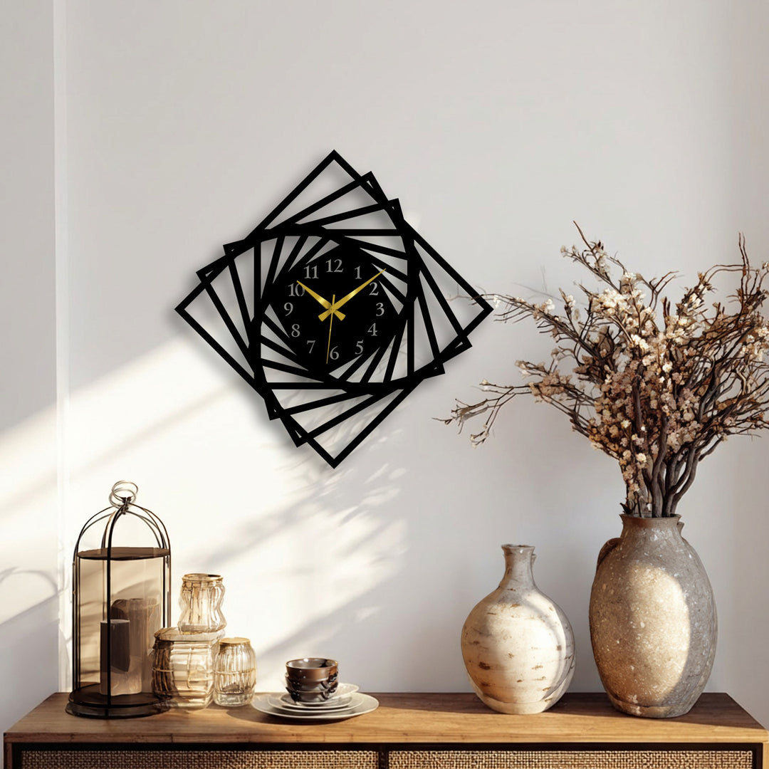 The stillness of a modern geometric spiral frame metal wall decor clock with gold hands rests elegantly on a calm white wall.