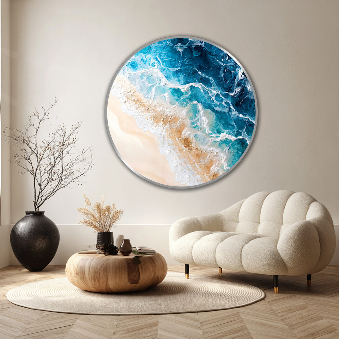Vast negative space accentuates the circular coastal oil painting wall art, highlighting the contrast between the turquoise ocean and the serene, sandy beach.