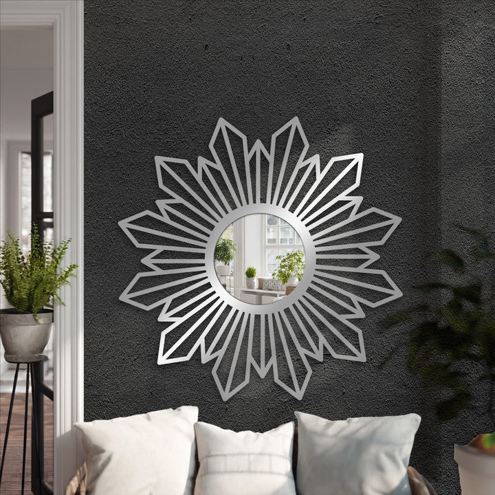 Radiant sunburst geometric metal decoration wall art mirror makes a loud statement above the seating area with its modern and radiant design.