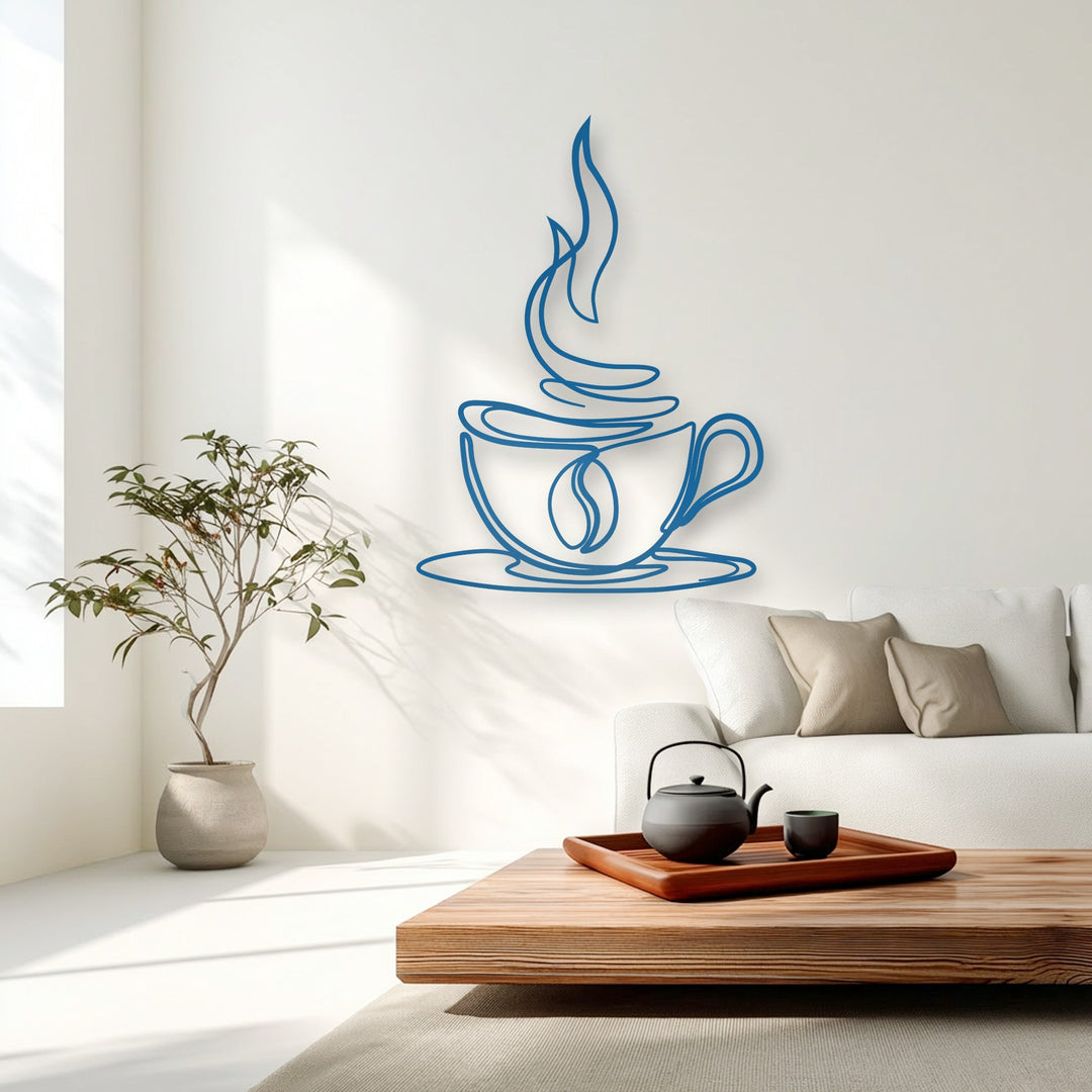 A deep layered perspective from the foreground wooden coffee table, past the white sofa, to a prominent blue coffee cup decorative metal art on the crisp white wall.