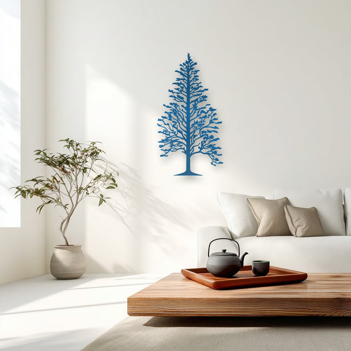 The black cast iron teapot and charcoal grey tea cup contrast with the elegant deep blue majestic pine tree metal wall decor.
