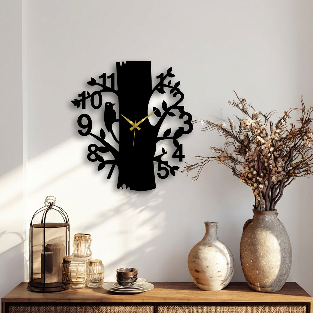 Minimal color saturation accentuates the black metal artwork clock shaped like a tree with a bird, a nature design that adds charm.