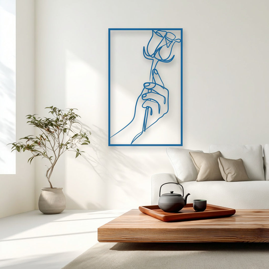 The elegant line art of the minimalist hand holding a rose decorative metal art creates a graceful visual rhythm on the wall.