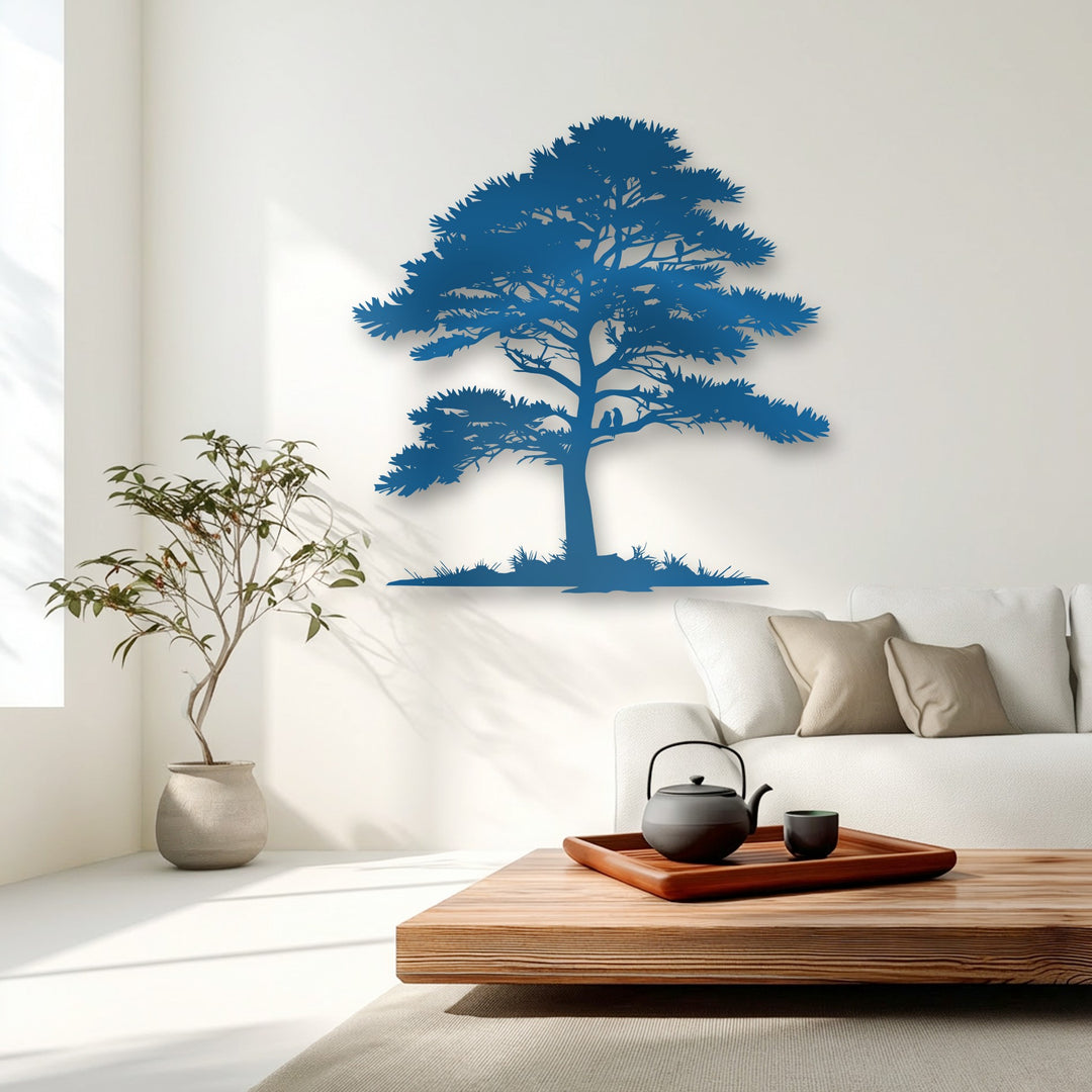 A light wooden coffee table holds a dark cast iron teapot and matching cup on a brown tray, complementing the decorative metal art in the background.