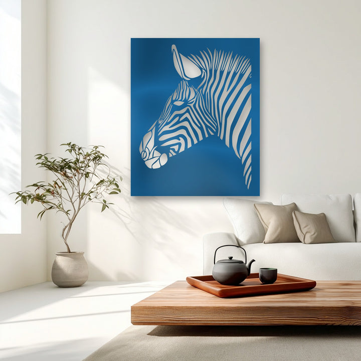 The smooth, glossy surface of this metal art for wall displays a silver-toned zebra with striking metallic sheen against a deep blue backdrop.