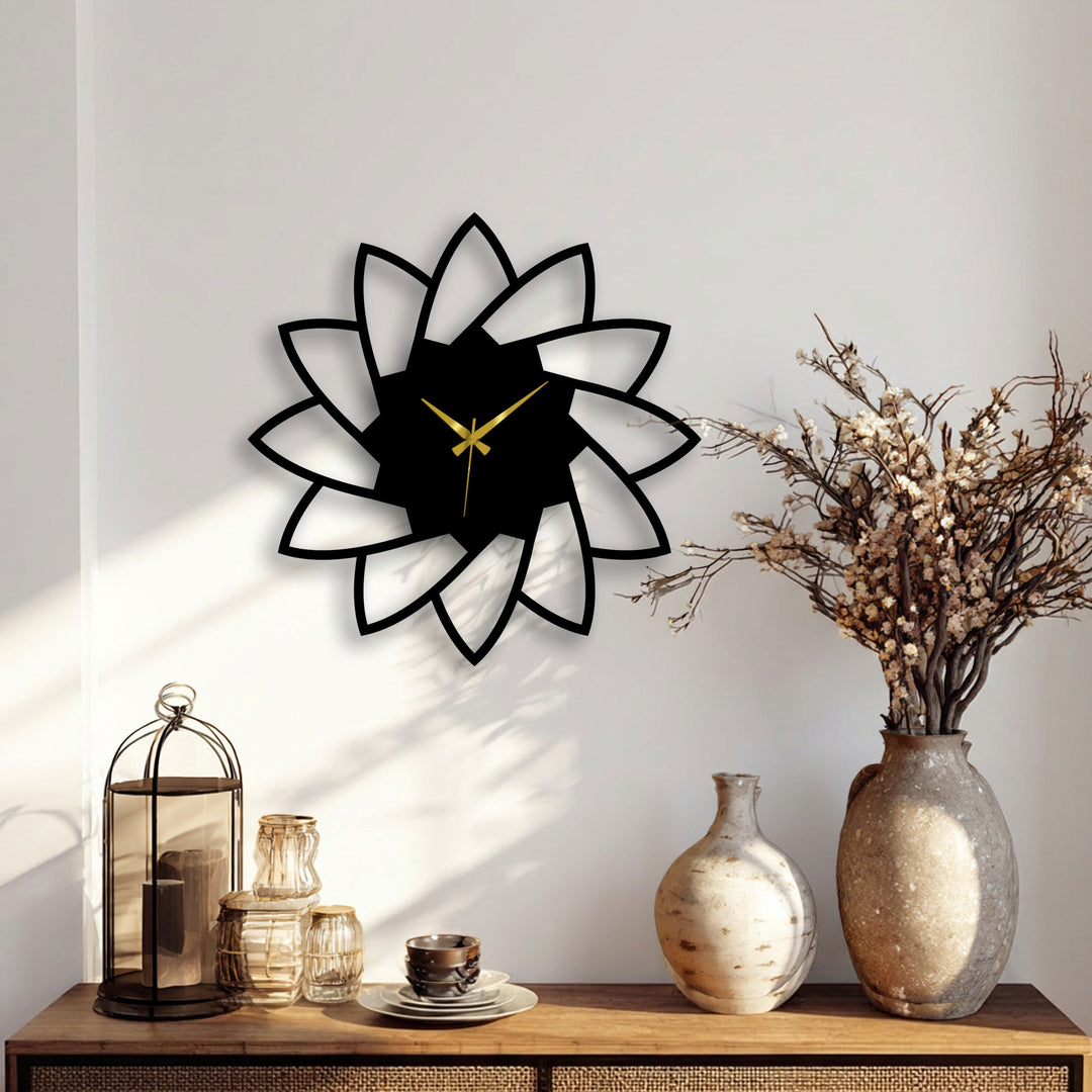 Detailed lotus bloom decorative metal art wall clock with a minimal floral design shows the texture of the wall and subtle shadows.