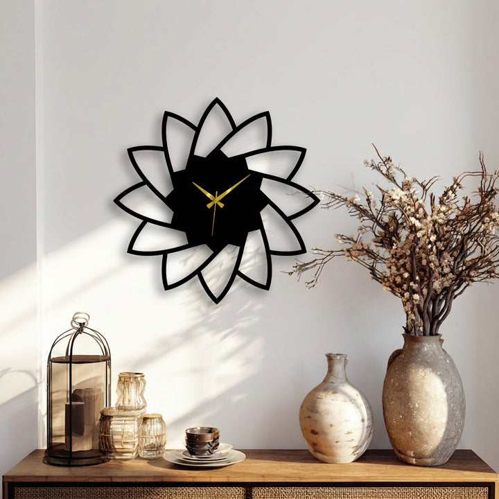 Detailed lotus bloom decorative metal art wall clock with a minimal floral design shows the texture of the wall and subtle shadows.