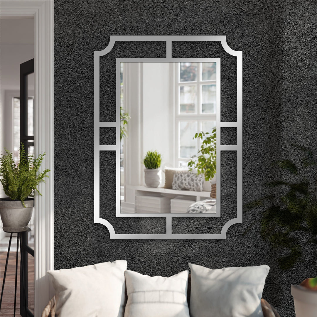 The stillness of the geometric metal wall mirror reflects a peaceful scene, a modern decoration wall art piece with minimalist frame design.