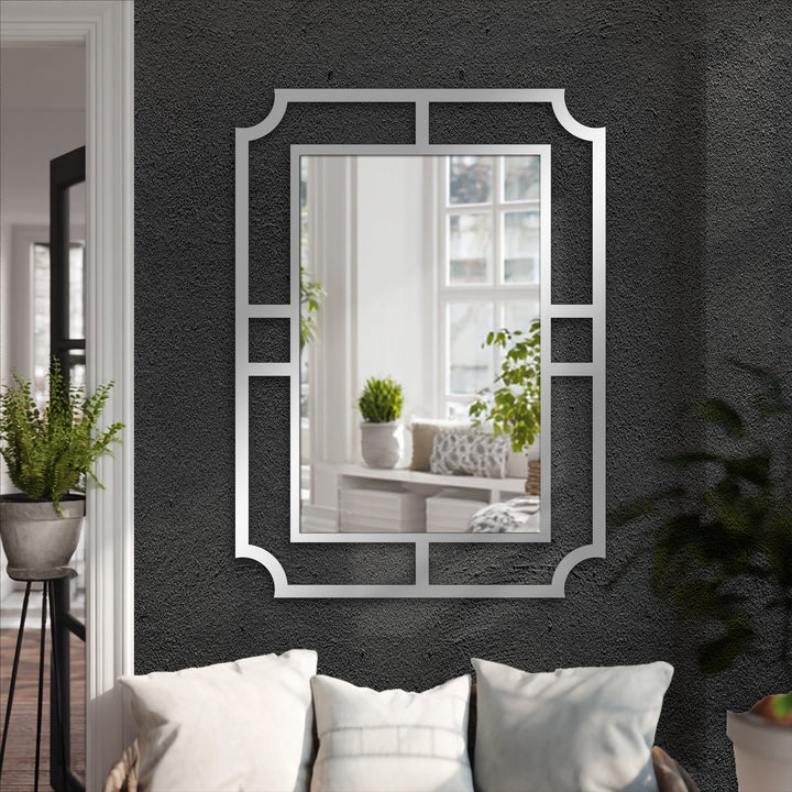 The stillness of the geometric metal wall mirror reflects a peaceful scene, a modern decoration wall art piece with minimalist frame design.