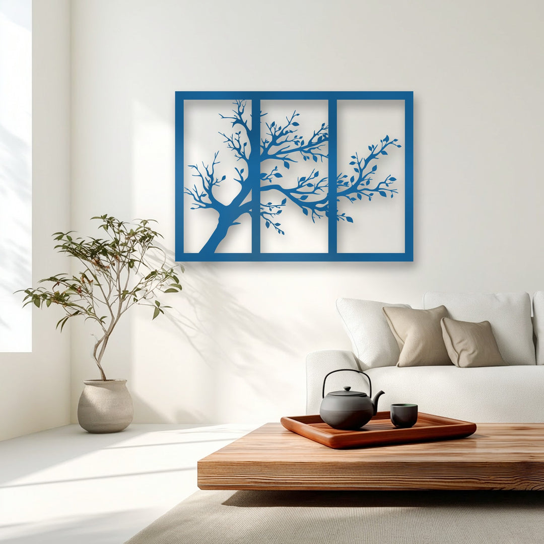 Deep shadow effects behind the azure minimalist tree silhouette metal wall decor highlight its layered design against the crisp white wall.