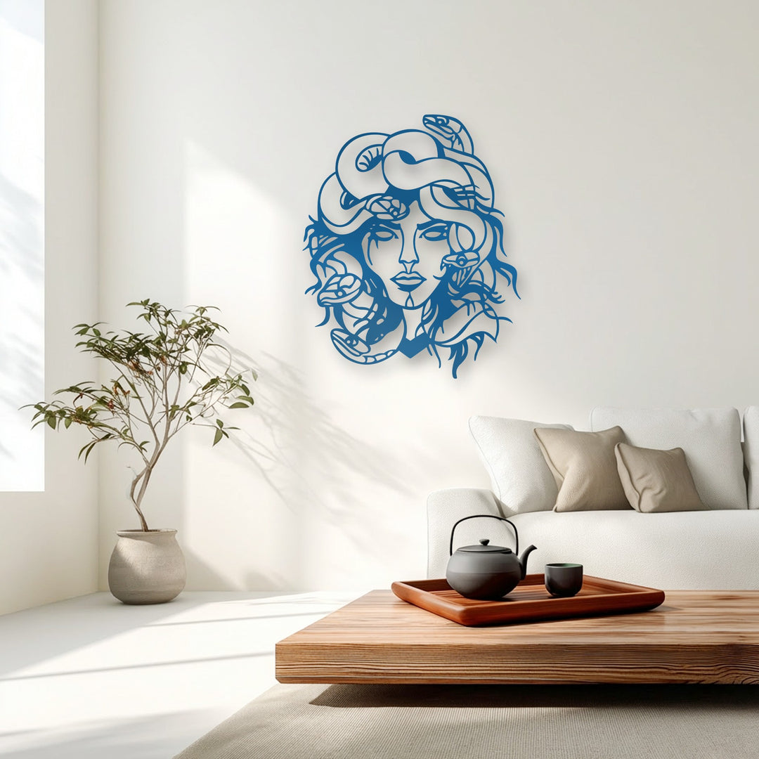 The realistic detail of the deep blue Medusa unique metal wall art, featuring intricate snakes, stands out in a bright, modern living room.