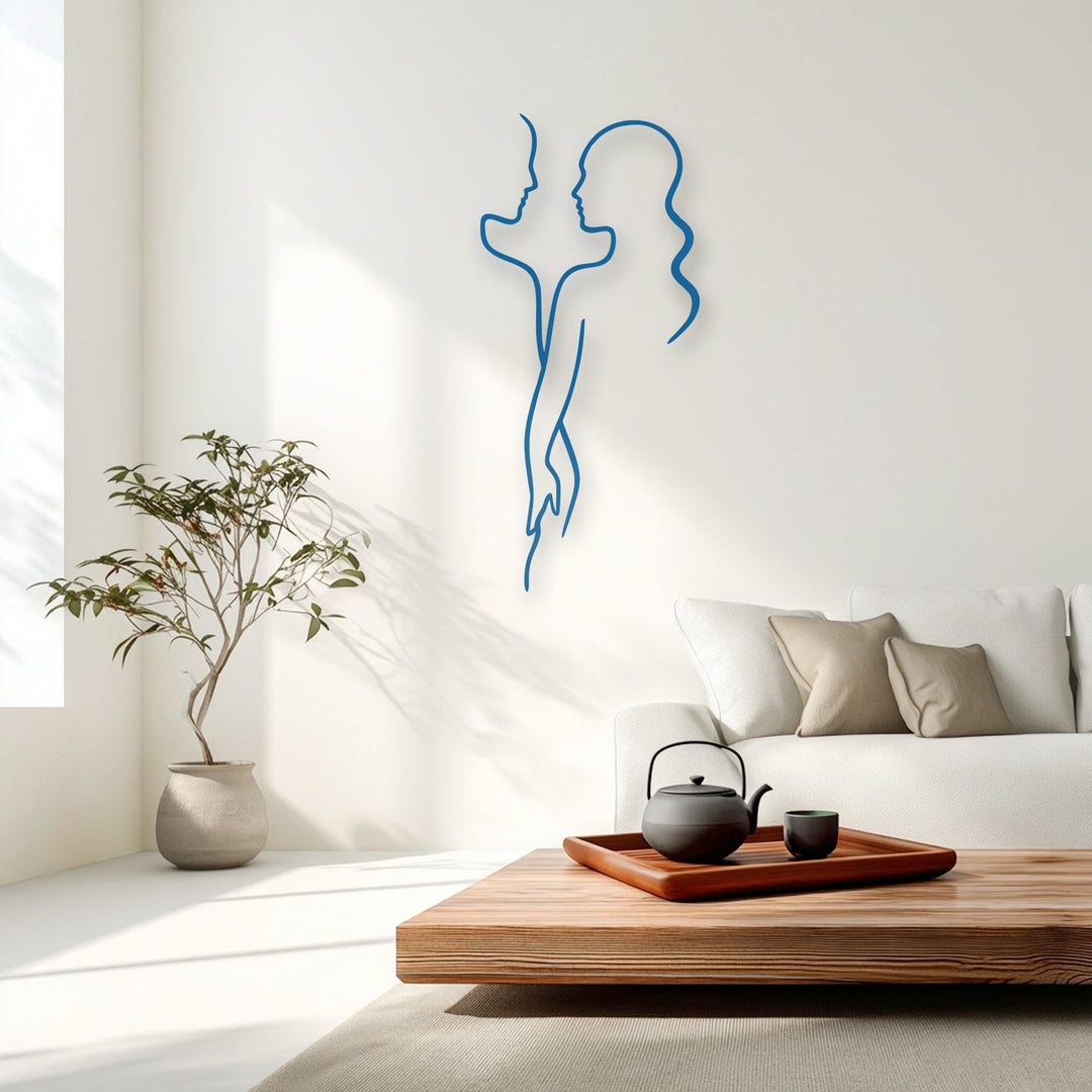 With notably low color saturation, a striking blue minimal couple line metal art for wall elegantly adorns a bright, modern living room.