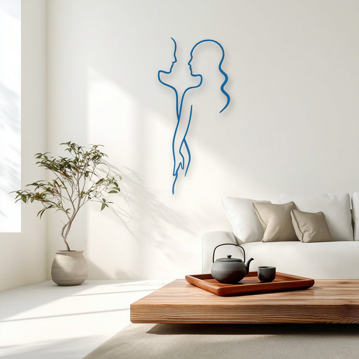 With notably low color saturation, a striking blue minimal couple line metal art for wall elegantly adorns a bright, modern living room.