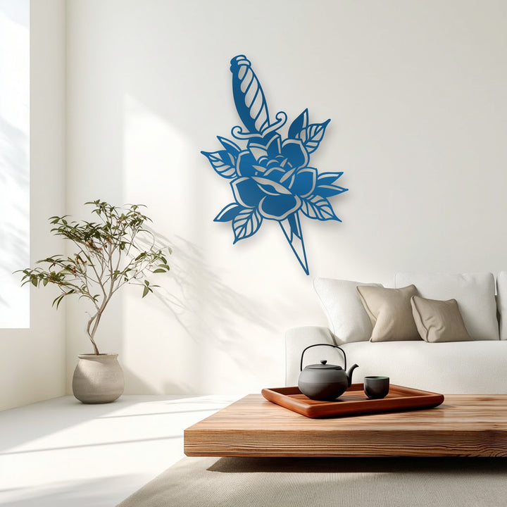 Sweeping sunlit shadows dynamically play across a crisp white wall, enhancing the bold blue Rose & Dagger Silhouette metal decoration wall art.