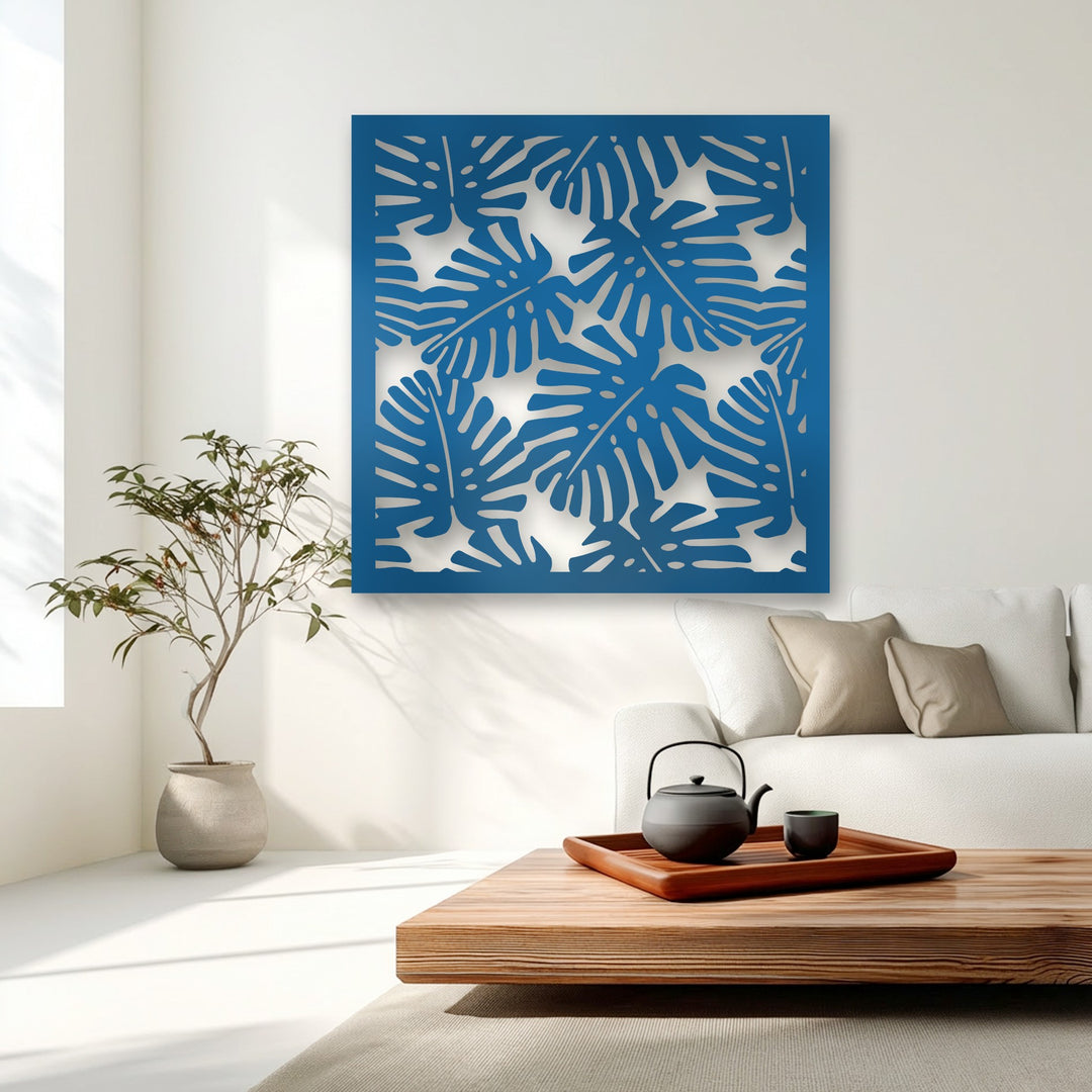 The visual rhythm of the azure decorative metal art, featuring monstera leaf patterns, casts dynamic light and shadow across the modern room.