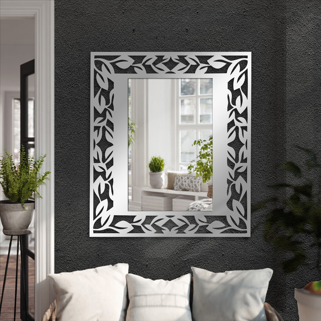 Botanical-inspired leaf pattern frame provides a unique metal wall art mirror with an elegant border, making it the loudest element in modern decorating with wall mirrors.