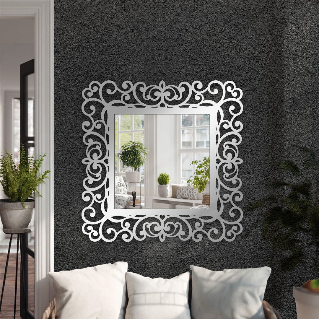Featuring subdued color saturation, the ornate scrollwork around this decorative mirror showcases a reflective scene of a softly lit interior.