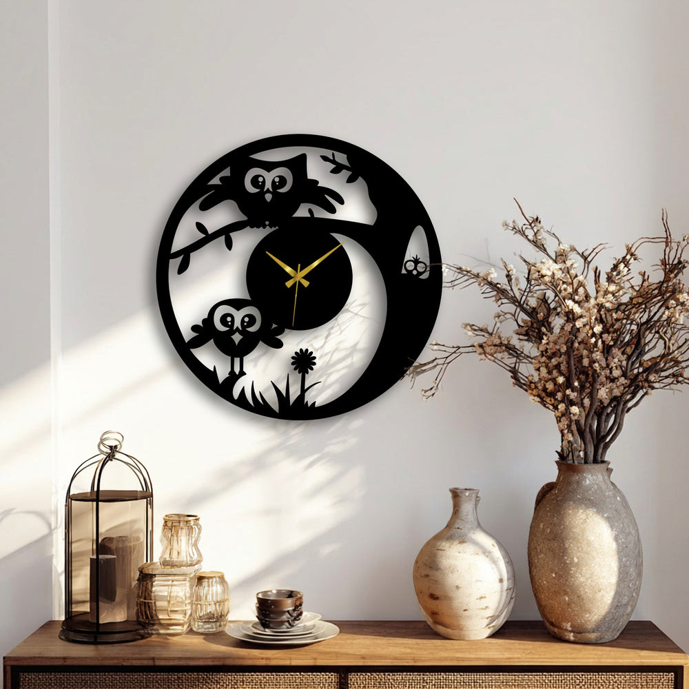 Softly illuminated by the light, the wall behind this playful owl metal wall clock adds to the home decor with its silent gold hands and nature design.